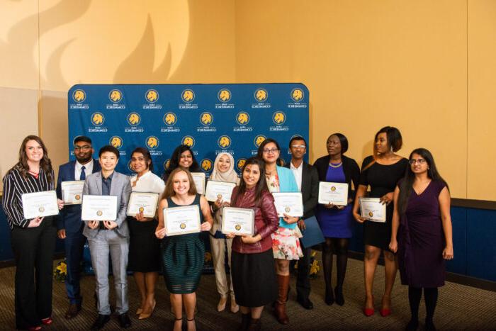 Group photo of students from TAMUC College of Business holding their certificates.